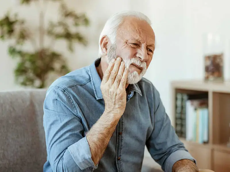 Older man experiencing tooth pain
