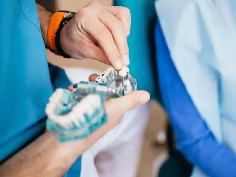 Dentist fitting a dental bridge